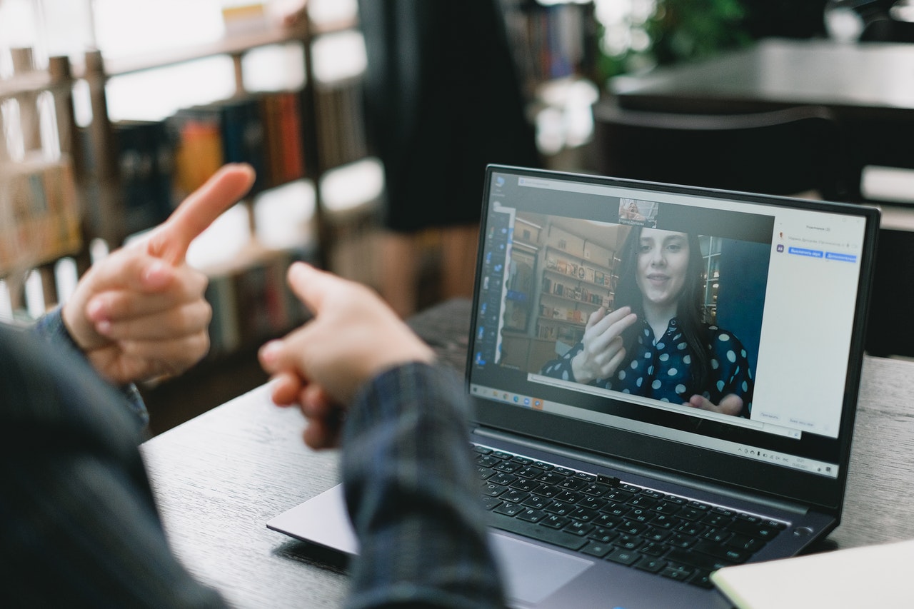 woman using sign language on laptop